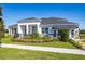 Charming home featuring a manicured lawn, dark roof, a black metal fence, and white columns at 2739 Ravencliffe Ter, Oviedo, FL 32765