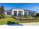 Charming home featuring a manicured lawn, dark roof, a black metal fence, and white columns at 2739 Ravencliffe Ter, Oviedo, FL 32765