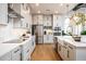 Modern kitchen boasts white cabinets, stainless steel appliances, a kitchen island and hardwood floors at 2739 Ravencliffe Ter, Oviedo, FL 32765