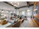 Open-concept living room with modern furnishings, hardwood floors, a coffered ceiling, and large windows at 2739 Ravencliffe Ter, Oviedo, FL 32765