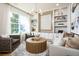 Inviting living room featuring built-in shelving, modern decor, and large windows providing natural light at 2739 Ravencliffe Ter, Oviedo, FL 32765