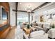 Open-concept living room with modern furnishings, hardwood floors, a coffered ceiling, and access to a patio at 2739 Ravencliffe Ter, Oviedo, FL 32765