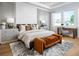 Comfortable bedroom with decorative accent wall, bench, and large windows that offer plenty of natural light at 2739 Ravencliffe Ter, Oviedo, FL 32765