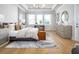 Large primary bedroom featuring a tray ceiling, multiple windows, and neutral decor, creating a relaxing retreat at 2739 Ravencliffe Ter, Oviedo, FL 32765