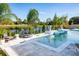 A luxurious pool with a sun shelf and beautiful landscaping, ideal for relaxation and outdoor gatherings at 2739 Ravencliffe Ter, Oviedo, FL 32765