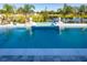 Sparkling swimming pool featuring a built-in sun shelf, enhanced by meticulously designed hardscape and landscape elements at 2739 Ravencliffe Ter, Oviedo, FL 32765