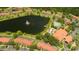 Aerial view showcasing the community's pool, lake, and manicured landscaping at 3019 White Orchid Rd, Kissimmee, FL 34747