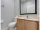 Powder room features a toilet, vanity with light wood cabinets, and a mirror at 3019 White Orchid Rd, Kissimmee, FL 34747
