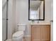 Bathroom featuring a vanity, toilet, framed mirror, and a glass enclosed shower at 3019 White Orchid Rd, Kissimmee, FL 34747