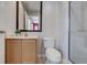 Bathroom with a vanity, toilet, framed mirror, and a glass enclosed shower at 3019 White Orchid Rd, Kissimmee, FL 34747