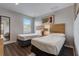 Bedroom with 2 twin beds and wood look floors at 3019 White Orchid Rd, Kissimmee, FL 34747