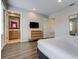 Bedroom with a dresser, TV, and doorways leading to a bathroom and closet at 3019 White Orchid Rd, Kissimmee, FL 34747