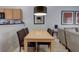 Elegant dining area adjacent to a living space, illuminated by modern pendant lighting at 3019 White Orchid Rd, Kissimmee, FL 34747