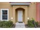 Close-up of an inviting townhome entrance with a white door and manicured landscaping at 3019 White Orchid Rd, Kissimmee, FL 34747