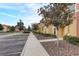 Street view of townhomes with colorful facades and meticulous landscaping under a bright sky at 3019 White Orchid Rd, Kissimmee, FL 34747