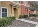 Close-up view of a townhome's charming facade, showcasing its inviting entrance and neat landscaping at 3019 White Orchid Rd, Kissimmee, FL 34747