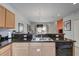 Well-lit kitchen featuring granite countertops, wooden cabinets, and an open view to the living area at 3019 White Orchid Rd, Kissimmee, FL 34747