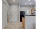 Bright kitchen area with tile flooring, modern black appliances, and ample countertop space at 3019 White Orchid Rd, Kissimmee, FL 34747