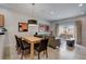Open-concept living and dining area with modern furnishings and access to outdoor patio at 3019 White Orchid Rd, Kissimmee, FL 34747