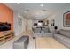 Open concept living room with tile floors and dining area and television at 3019 White Orchid Rd, Kissimmee, FL 34747