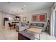 Open concept living room with tile floors and dining area with natural light from sliding glass door at 3019 White Orchid Rd, Kissimmee, FL 34747