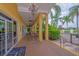 Charming covered patio with ceiling fans and outdoor dining tables at 3019 White Orchid Rd, Kissimmee, FL 34747