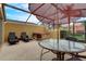 Screened-in patio with a hot tub, seating, and an umbrella covered table at 3019 White Orchid Rd, Kissimmee, FL 34747
