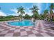 Resort-style pool surrounded by palm trees and lounge chairs at 3019 White Orchid Rd, Kissimmee, FL 34747