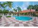 Resort-style pool surrounded by palm trees and lounge chairs at 3019 White Orchid Rd, Kissimmee, FL 34747