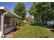 Lush, green backyard with mature trees, offering a serene and private outdoor space at 3121 Thistlehill Drive, Winter Park, FL 32792