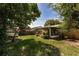 Spacious backyard view with lush grass, mature trees, and screened lanai, perfect for relaxing outdoors at 3121 Thistlehill Drive, Winter Park, FL 32792