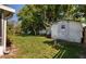 Well-maintained backyard with lush green lawn and storage shed, offering a private outdoor space at 3121 Thistlehill Drive, Winter Park, FL 32792
