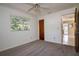 Bright bedroom with view to backyard offers neutral walls, soft carpet and ceiling fan for comfortable living at 3121 Thistlehill Drive, Winter Park, FL 32792