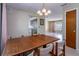 Traditional dining room featuring a wood table set and views into the living room and kitchen at 3121 Thistlehill Drive, Winter Park, FL 32792
