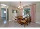 Cozy dining area with a classic chandelier and a large window at 3121 Thistlehill Drive, Winter Park, FL 32792