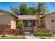 Close-up of a charming home's entry with brick accents and a secure gate at 3121 Thistlehill Drive, Winter Park, FL 32792