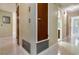 Hallway featuring multiple entryways and unique wall and floor textures at 3121 Thistlehill Drive, Winter Park, FL 32792