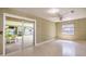 Living room with a ceiling fan, bright windows, and sliding door access to an enclosed porch at 3121 Thistlehill Drive, Winter Park, FL 32792