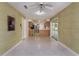 Open living room with bright windows, ceiling fan and access to the kitchen and enclosed porch at 3121 Thistlehill Drive, Winter Park, FL 32792