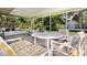 Outdoor living is easy with a spacious screened lanai furnished with a comfortable table set at 3121 Thistlehill Drive, Winter Park, FL 32792