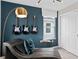 A room with an accent wall, modern lighting, and guitars displayed on the wall at 3304 Orange Rose Loop, Apopka, FL 32712