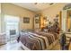 Cozy bedroom with a comfortable bed, natural light, and storage at 34239 Woodridge Ln, Eustis, FL 32736