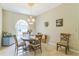Charming dining space with tile floors, a round table, and an elegant chandelier at 34239 Woodridge Ln, Eustis, FL 32736
