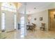 Bright dining area featuring tile flooring, a chandelier, and a large window for natural light at 34239 Woodridge Ln, Eustis, FL 32736