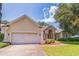 Charming single-story home with a well-manicured lawn and a two-car garage, perfect for suburban living at 34239 Woodridge Ln, Eustis, FL 32736