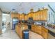Well-equipped kitchen with custom wood cabinets, granite countertops, and stainless steel appliances at 34239 Woodridge Ln, Eustis, FL 32736