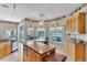 Eat-in kitchen with an island, stainless steel appliances, and outdoor views at 34239 Woodridge Ln, Eustis, FL 32736