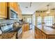 Bright kitchen features granite countertops, stainless steel appliances, and tile flooring at 34239 Woodridge Ln, Eustis, FL 32736