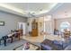 Open-concept living area featuring a grand piano, tile floors, and a tray ceiling with a ceiling fan at 34239 Woodridge Ln, Eustis, FL 32736