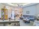 Expansive living area offering a grand piano, comfortable seating, and a view into the dining area at 34239 Woodridge Ln, Eustis, FL 32736